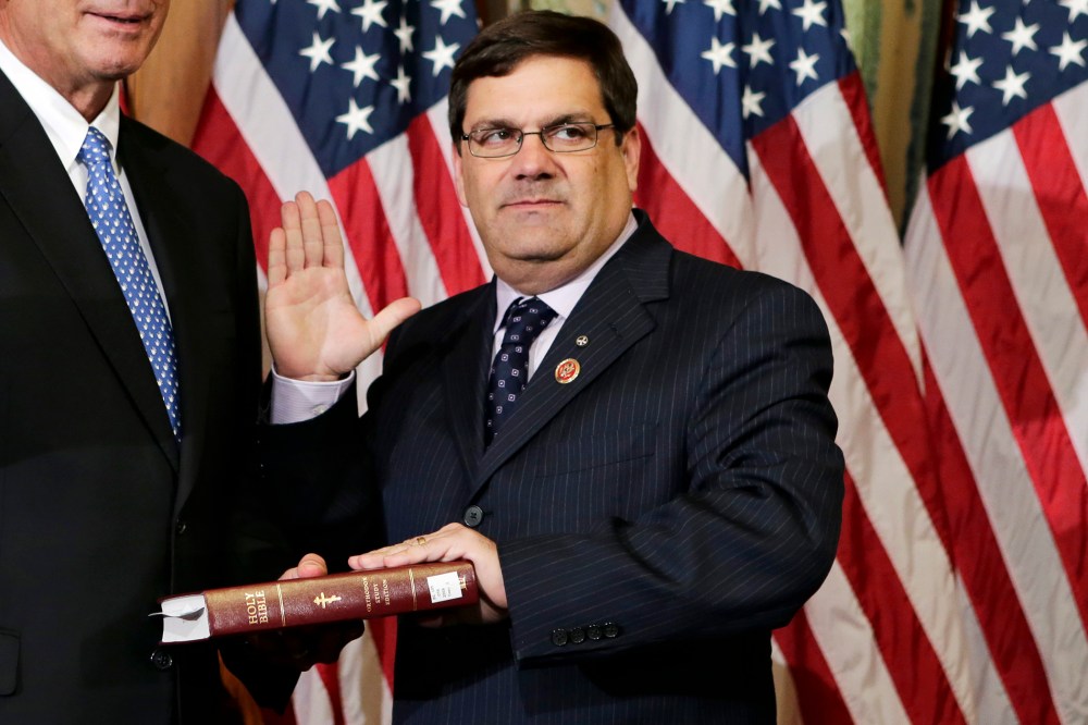 Rep. Gus M. Bilirakis, R-Fla., stands for a ceremonial photo in the Rayburn Room of the Capitol after the new 113th Congress convened on Jan. 3, 2013, in Washington. (Photo by J. Scott Applewhite/AP)