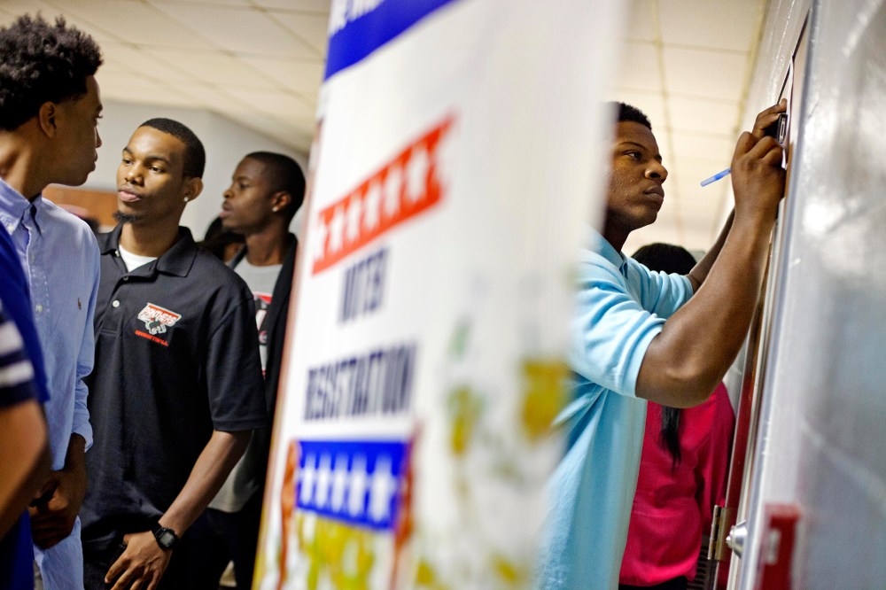 Students at Clark Atlanta University fill out voter registration forms, Sept. 18, 2012, in Atlanta, Ga. (Photo by David Goldman/AP)