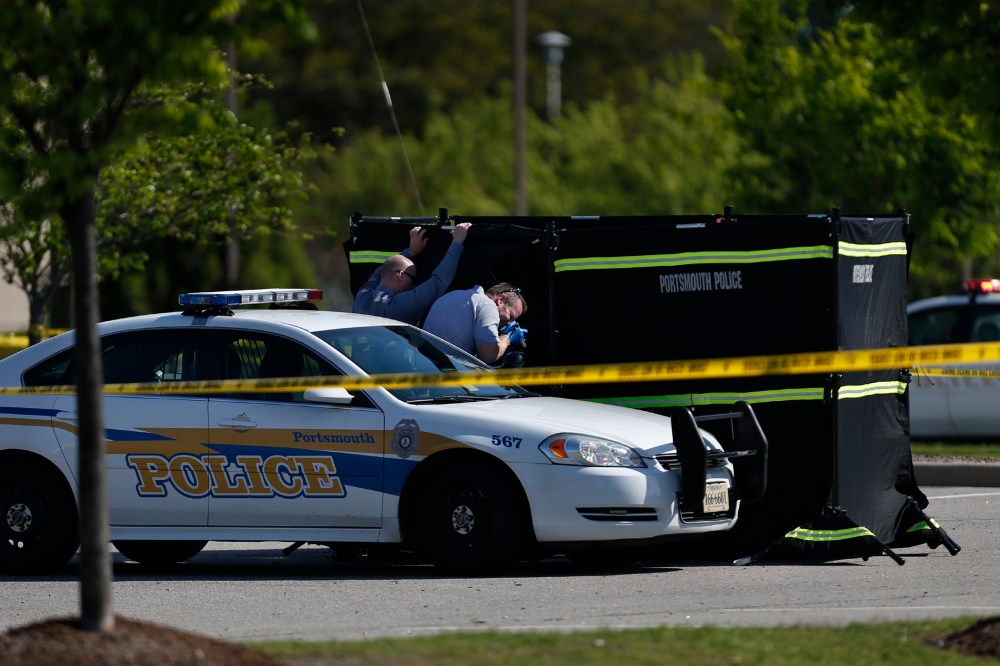 Authorities collect evidence and investigate a police involved shooting in a Wal-Mart parking lot on Wednesday, April 22, 2015 in Portsmouth, Va. (Photo by Stephen M. Katz/The Virginian-Pilot/AP)