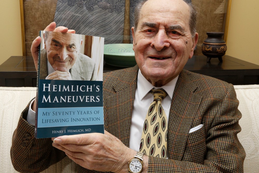In this Wednesday, Feb. 5, 2014 photo, Dr. Henry Heimlich holds his memoirs prior to being interviewed at his home in Cincinnati. (Photo by Al Behrman/AP)