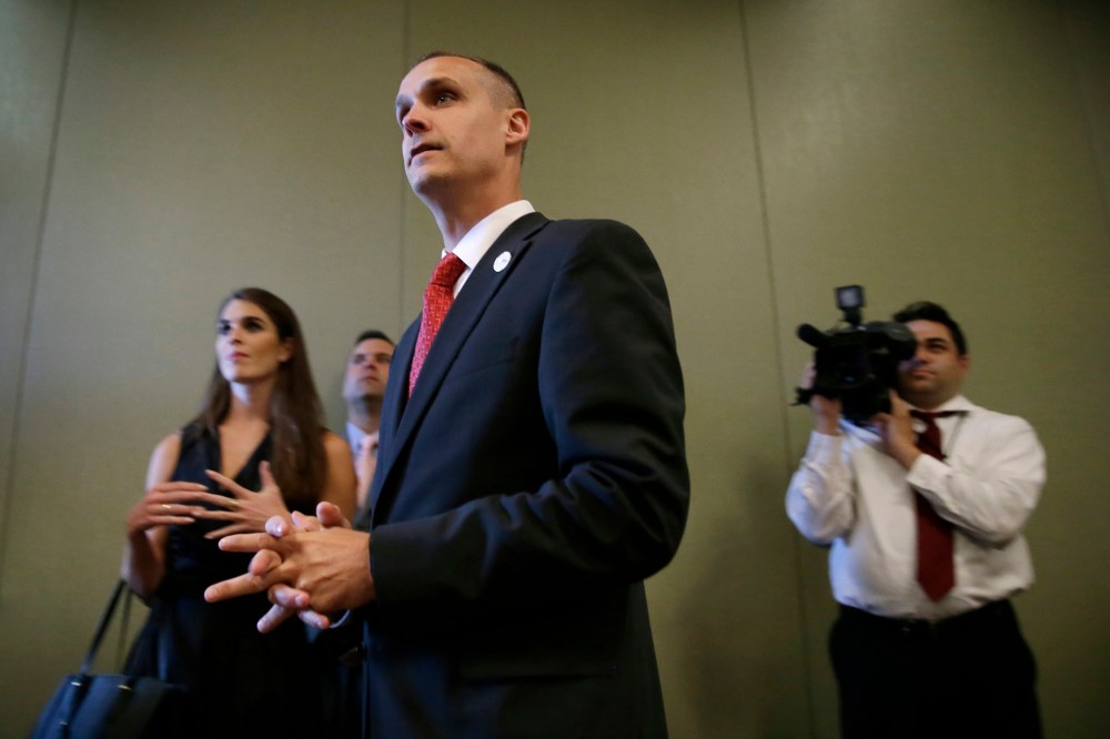 In this photo taken Aug. 25, 2015, Republican presidential candidate Donald Trump's campaign manager Corey Lewandowski watches as Trump speaks in Dubuque, Iowa. (Photo by Charlie Neibergall/AP)