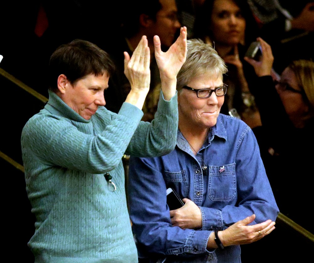 Kody Partridge, left, and her wife, Laurie Wood celebrate after the Republican-controlled Utah Legislature passes a anti-discrimination bill, March 11, 2015, in Salt Lake City. (Photo by Rick Bowmer/AP)