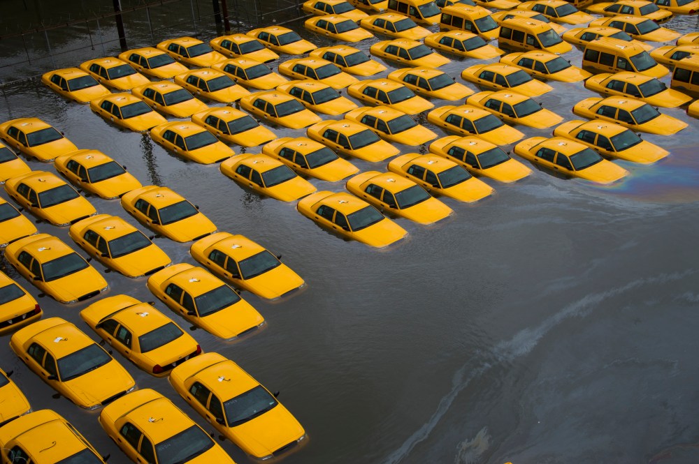 A parking lot full of yellow cabs is flooded as a result of Hurricane Sandy in Hoboken, NJ. (AP Photo/Charles Sykes)