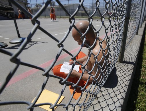 Inmate Curtis Colvard Sr. reads a Bible in the exercise yard of Sacramento County's Rio Cosumnes Correctional Center in Elk Grove, Calif., Thursday, May 30, 2013. A report by the California Little Hoover Commission says Gov. Jerry Brown's prison...