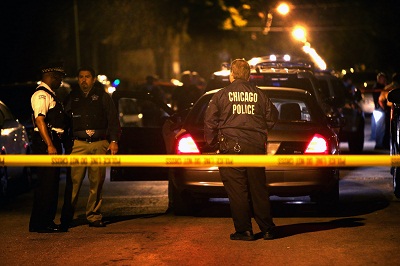Police investigate the scene where a 15-year-old boy was shot and killed by police after he reportedly pointed a gun at officers during a foot chase on June 17, 2013 in Chicago. (Photo by Scott Olson/Getty Images)