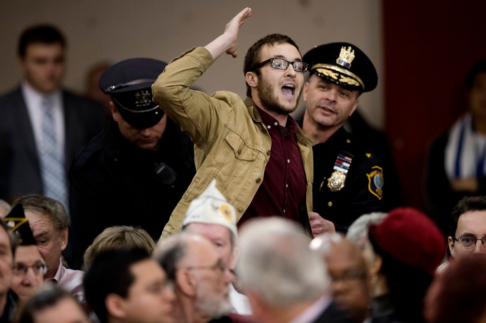 Rowan University student Michael Brein shouts at New Jersey Gov. Chris Christie, as he is removed from a town hall meeting, on March 13, 2014, in Mount Laurel, N.J.
