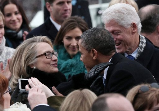 U.S. President Barack Obama greets Secretary of State Hillary Clinton and former President Bill Clinton during the presidential inauguration on the West Front of the U.S. Capitol in Washington January 21, 2013. REUTERS/Win McNamee/Pool (UNITED STATES...