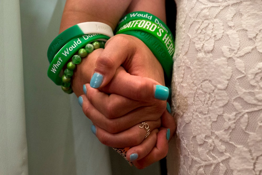 Jillian Soto, left, and Carlee Soto, sisters of Newtown, Conn. shooting victim Victoria Soto, hold hands during a news conference on Capitol Hill in Washington, Thursday, June 13, 2013, (AP Photo/Jacquelyn Martin)