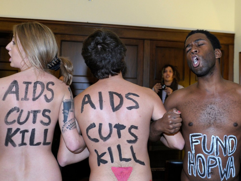 Naked AIDS activists, with painted slogans on their bodies, protested inside the lobby of the Capitol Hill office of House Speaker John Boehner on Tuesday, prior to World AIDS Day. (Susan Walsh/AP Photo)
