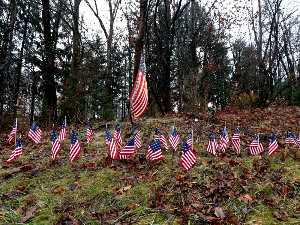 Twenty-seven small U.S. flags adorn a large flag on a makeshift memorial on the side of Highway 84 near the Newtown, Conn., town line as residents mourn victims killed by gunman Adam Lanza, Monday, Dec. 17, 2012. On Friday, authorities say Lanza killed...