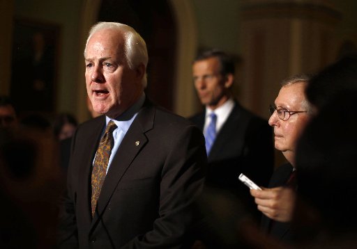 .S. Senate Minority Leader Mitch McConnell (R-KY)(R) watches as John Cornyn (R-TX) speaks to the press on Capitol Hill in Washington, November 14, 2012. Republicans in the U.S. Senate voted Cornyn as the new minority whip on Wednesday.   REUTERS/Jason...