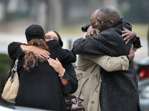 Ron Davis, the father of Jordan Davis is embraced as he arrives at the funeral home for the visitation and a memorial service for his son Jordan, Wednesday, Nov. 28, 2012 in Jacksonville, Fla.(Photo by Bob Self/AP Photo/The Florida Times-Union)