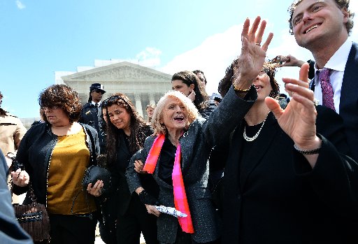 Plaintiff of the US v. Windsor case challenging the constitutionality of Section 3 of the Defense of Marriage Act (DOMA), 83-year-old lesbian widow Edie Windsor (C), greets same-sex marriage supporters as she leaves the Supreme Court on March 27. ...