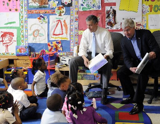 U.S. Education Secretary Arne Duncan and Michigan Gov. Rick Snyder read "The Rainbow Fish" book to a pre-kindergarten class at Thirkell Elementary School in Detroit on Monday, May 6, 2013. (AP Photo/Detroit News, David Coates)