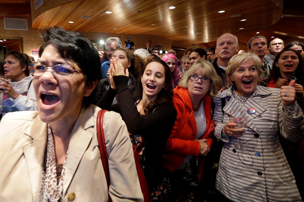 Supporters cheer as results come in at an election night party for Initiative 594, a measure seeking universal background checks on gun sales and transfers, on Nov. 4, 2014, in Seattle.