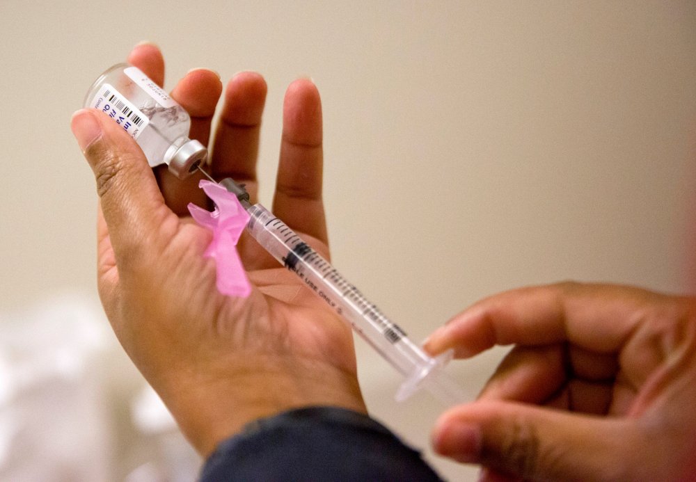 A nurse prepares a flu shot at the Salvation Army in Atlanta, Wednesday, Feb. 7, 2018.