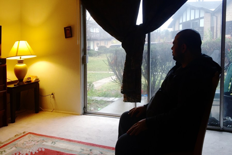 Amjad looks out the window of his house in Ohio. (Photo by Amanda Sakuma)
