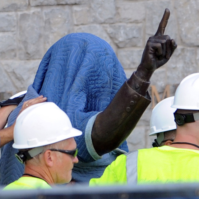 July 22, 2012 - State College, Pa. - Penn State workers cover the statue of former coach Joe Paterno near Beaver Stadium on Penn State's campus Sunday as they prepare to remove it.