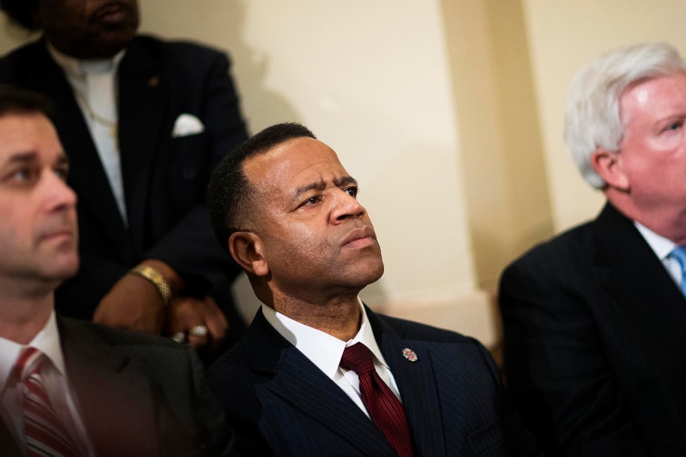 Former Atlanta fire chief Kelvin Cochran, second from left, listens during a rally by religious groups supporting Cochran following his termination, on Jan. 13, 2015, in Atlanta. (Photo by David Goldman/AP)