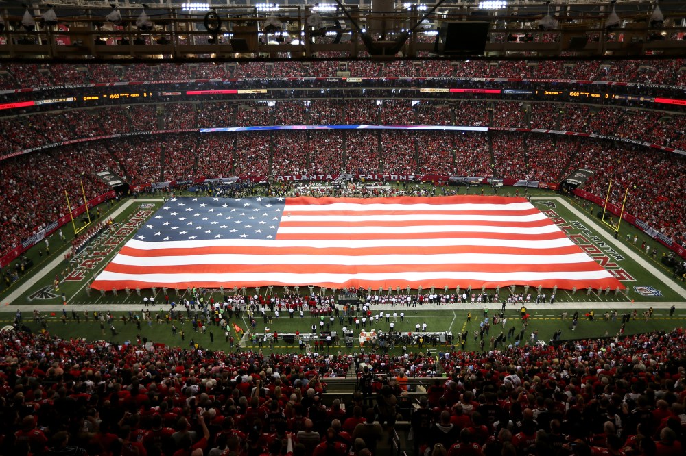 The United States flag covers the field during the national anthem before the Atlanta Falcons take on the San Francisco 49ers at the Georgia Dome on Jan. 20, 2013 in Atlanta, Ga. (Photo by Mike Ehrmann/Getty)