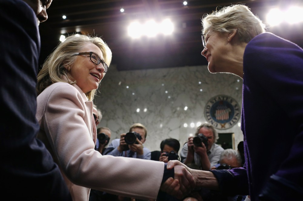 Hillary Clinton greets Sen. Elizabeth Warren as they arrive for Sen. John Kerry's confirmation hearing in the Hart Senate Office Building on Capitol Hill Jan. 24, 2013 in Washington, DC. (Photo by Chip Somodevilla/Getty)