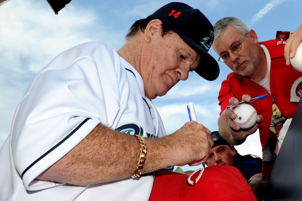 Former Major League Baseball player Pete Rose signs an autograph prior to managing the game for the Bridgeport Bluefish against the Lancaster Barnstormers on June 16, 2014 in Bridgeport, Conn. (Photo by Christopher Pasatieri/Getty)