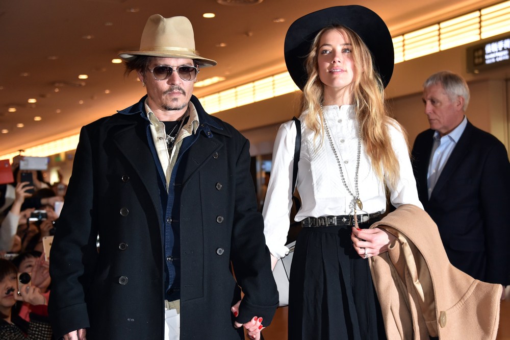 Actor Johnny Depp (L), accompanied by his fiancee US actress and model Amber Heard (R), arrive at Tokyo International Airport on Jan. 26, 2015. (Photo by Yoshikazu Tsuno/AFP/Getty)
