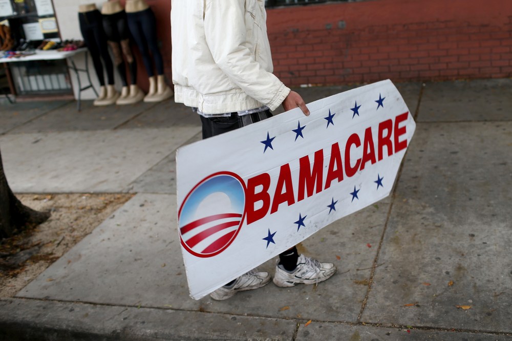 Pedro Rojas holds a sign directing people to an insurance company where they can sign up for the Affordable Care Act, also known as Obamacare, before the February 15th deadline on Feb. 5, 2015 in Miami, Fla. (Joe Raedle/Getty)