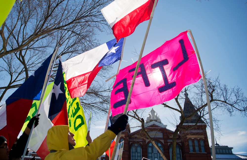 A group from Texas display their flags during a rally on the Mall for the March for Life anti-abortion demonstration. (Photo By Tom Williams/CQ Roll Call/Getty)