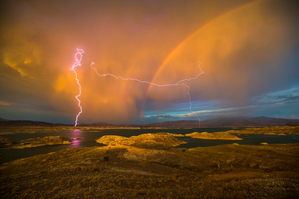 Lightning strikes near a rainbow over Lake Mead National Recreation Area in Lake Mead, Nev. on Jul. 1, 2015 (Photo by Allen J. Schaben/Los Angeles Times/Getty).