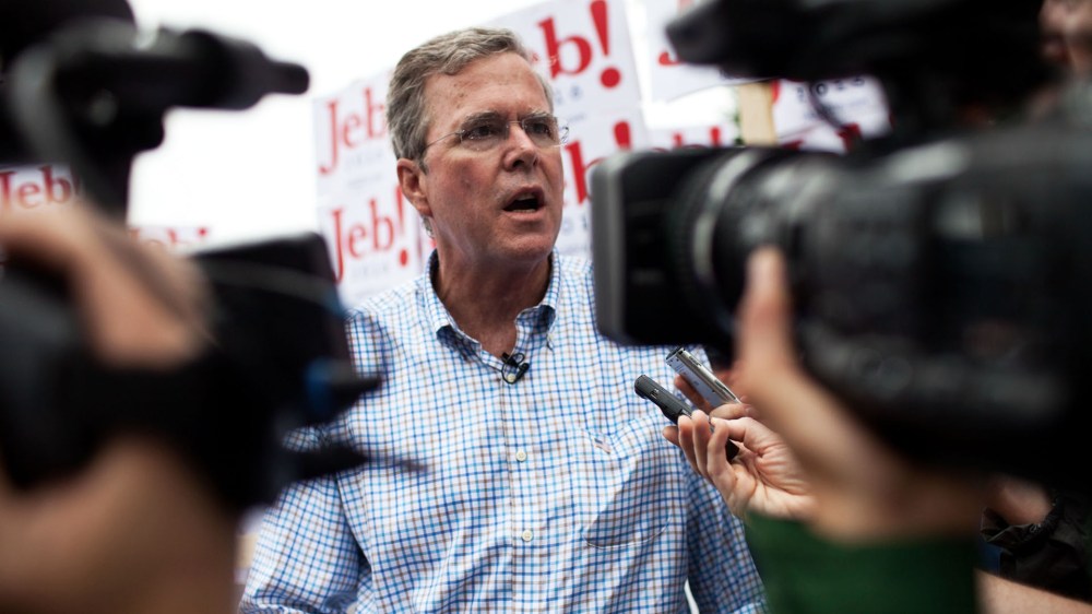 Republican Presidential candidate Jeb Bush speaks to the press at the 4th of July Parade in Merrimack, N.H. (Photo by Kayana Szymczak/Getty)