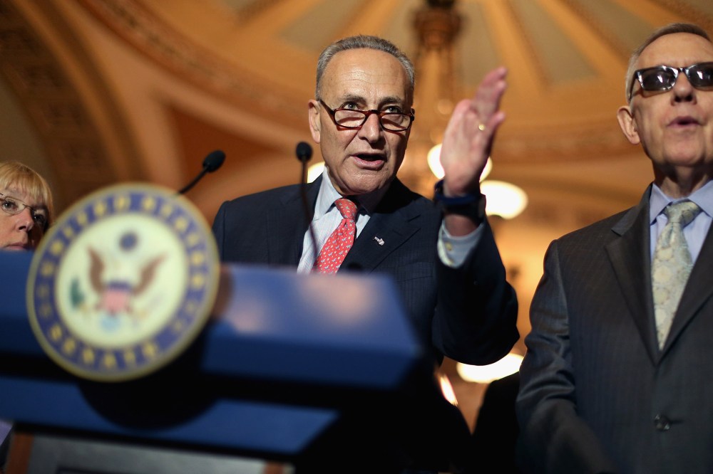 Sen. Charles Schumer and Senate Minority Leader Harry Reid talk with reporters after the weekly Democratic policy luncheon at the U.S. Capitol on Aug. 4, 2015 in Washington, DC. (Photo by Chip Somodevilla/Getty)
