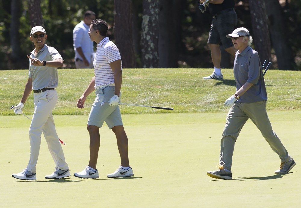 U.S. President Barack Obama walks alongside Cyrus Walker and comedian Larry David as they play golf at Farm Neck Golf Club in Oak Bluffs on Martha's Vineyard, Mass., Aug. 8, 2015. (Photo by Saul Loeb/AFP/Getty)