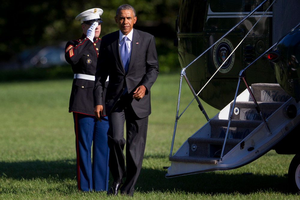 President Barack Obama walks off of Marine One after landing on the South Lawn of the White House on Aug. 25 in Washington, DC. (Photo by Andrew Harrer/Pool/Getty)