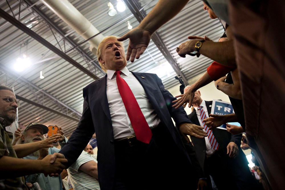Republican presidential candidate Donald Trump greets attendees during a rally at Grand River Center in Dubuque, Iowa, Aug. 25, 2015. (Photo by Daniel Acker/Bloomberg/Getty)