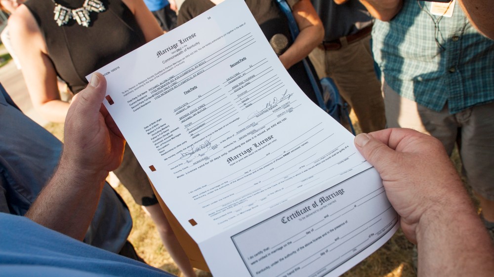 Timothy Long, of Rowan County, holds up a completed and legal marriage license he and his partner, Michael Long, received at the Rowan County Courthouse on Sept. 4, 2015 in Morehead, Kentucky. (Photo by Ty Wright/Getty)
