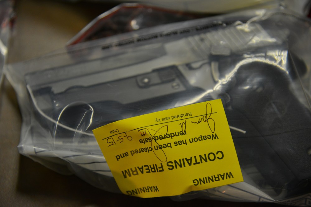Seized guns are displayed as Mayor Muriel Bowser and Metropolitan Police Department Chief Cathy Lanier speak about the city's illegal guns and gun violence, Sept. 8, 2015, in Washington, DC. (Photo by Jahi Chikwendiu/The Washington Post/Getty)