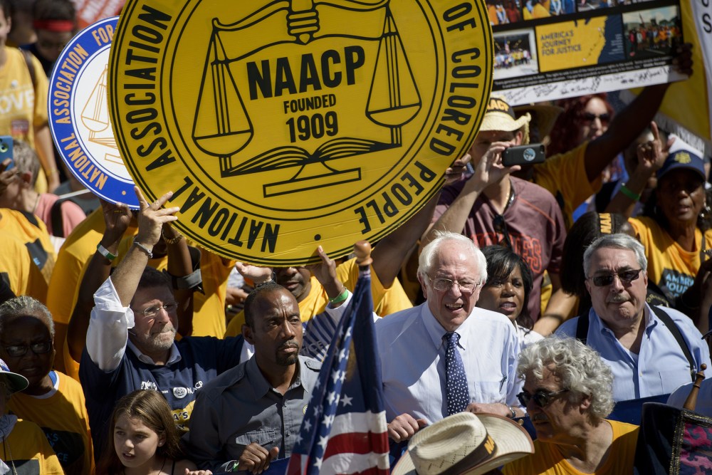 Presidential hopeful Bernie Sanders and Cornell William Brooks, president and CEO of the NAACP walk up the steps of the Lincoln Memorial during the march from Selma, Ala. to Washington, DC Sept. 15, 2015. (Photo by Brendan Smialowski/AFP/Getty)