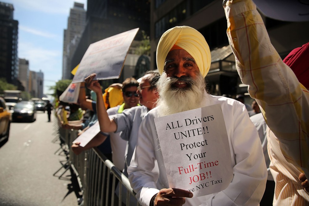 New York City taxi drivers hold a rally in front of Governor Andrew Cuomo's office to protest against recent inroads made by the Uber car service on Sept. 16, 2015 in New York City. (Photo by Spencer Platt/Getty)
