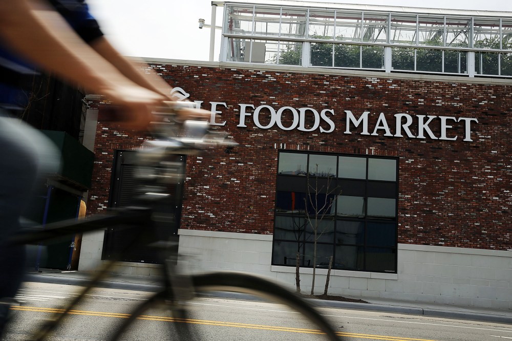 A person bikes past a Whole Foods Market in the Brooklyn borough on May 7, 2014 in New York City. (Photo by Spencer Platt/Getty)
