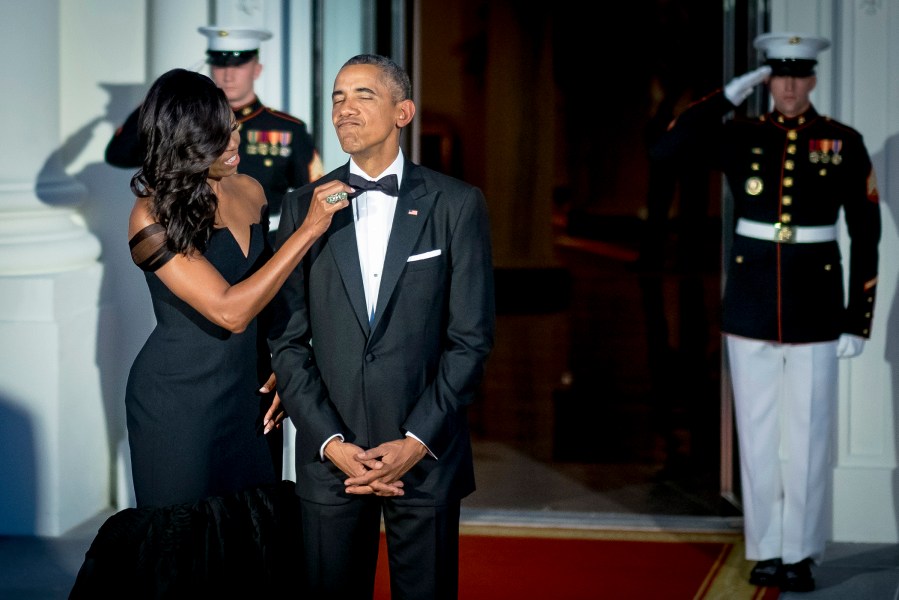 Michelle Obama adjusts President Obama's bow-tie prior to greeting Xi Jinping, China's president, and Peng Liyuan, China's first lady, both not pictured, on the North Portico of the White House, Sept. 25, 2015. (Photo by Pete Marovich/Bloomberg/Getty)