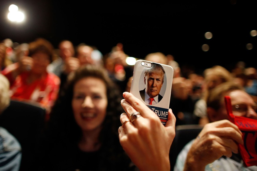A supporter of Republican presidential candidate Donald Trump takes video on her Trump-branded phone during a campaign rally at the Treasure Island Hotel & Casino on Oct. 8, 2015 in Las Vegas, Nev. (Photo by Isaac Brekken/Getty)
