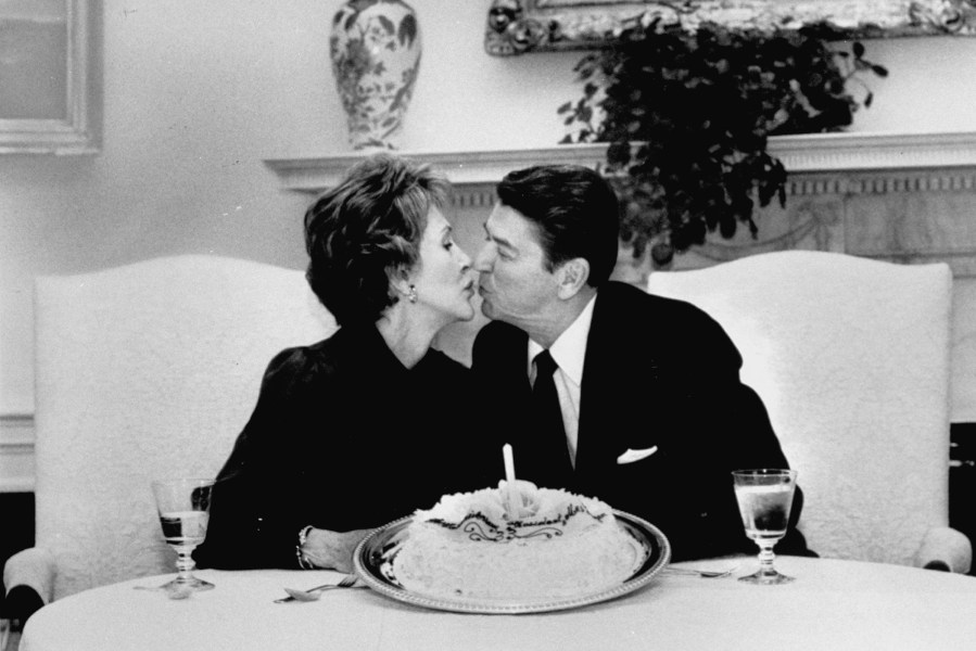 President Ronald Reagan kisses wife Nancy in the White House. (Photo by Jack Kightlinger/White House/The LIFE Picture Collection/Getty)
