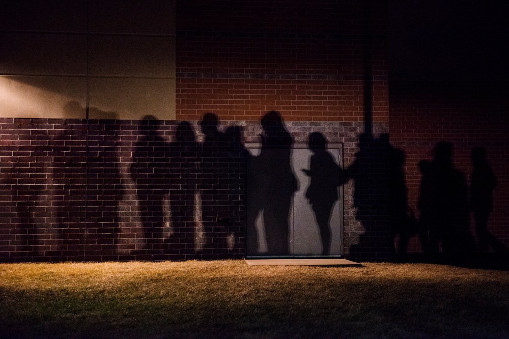The shadows of caucus goers lined up outside a Democrat Party caucus can be seen on the walls of Maple Grove Elementary in West Des Moines, Iowa. (Photo by Stephen Maturen/Getty)
