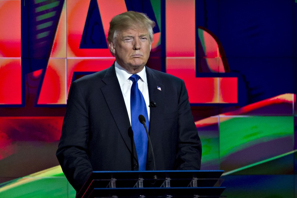 Donald Trump stands behind his podium during the Republican presidential primary candidate debate in Houston, Texas, Feb. 25, 2016. (Photo by Andrew Harrer/Bloomberg/Getty)