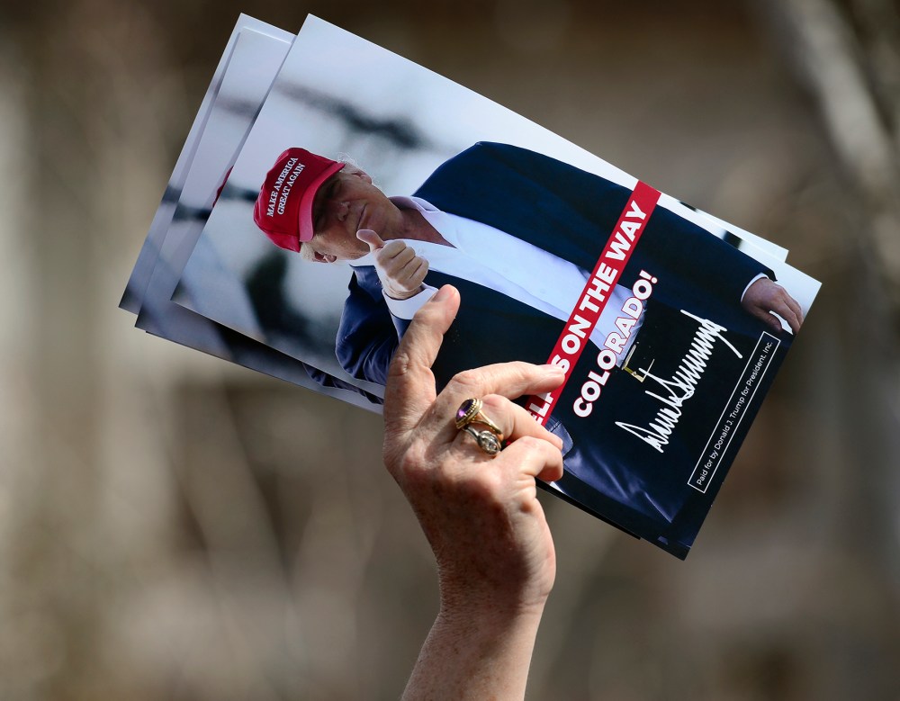 A woman holds leaflets for candidate Donald Trump at the Colorado District 2 meeting, April 8, 2016. (Photo by Kathryn Scott Osler/The Denver Post/Getty)