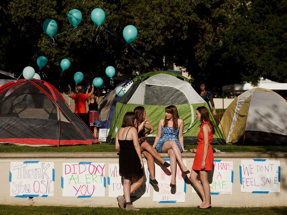 Carly Mee, a student at Occidental College, center, talks with other students during the Oxy Sexual Assault Coalition (OSAC) sexual assault awareness night campout at the college campus in Los Angeles, California, U.S., on Friday, April 19, 2013.