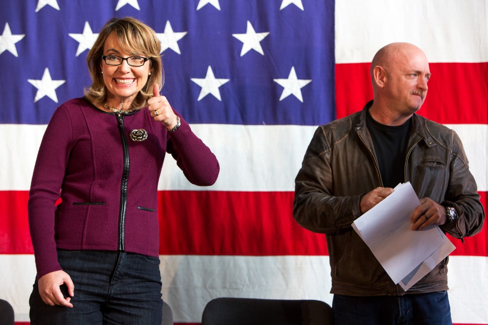 Gabby Giffords and her husband Mark Kelly are introduced at a fundraiser for U.S. Senate candidate Bruce Braley, Sunday, Oct. 27, 2013, in Des Moines, Iowa.