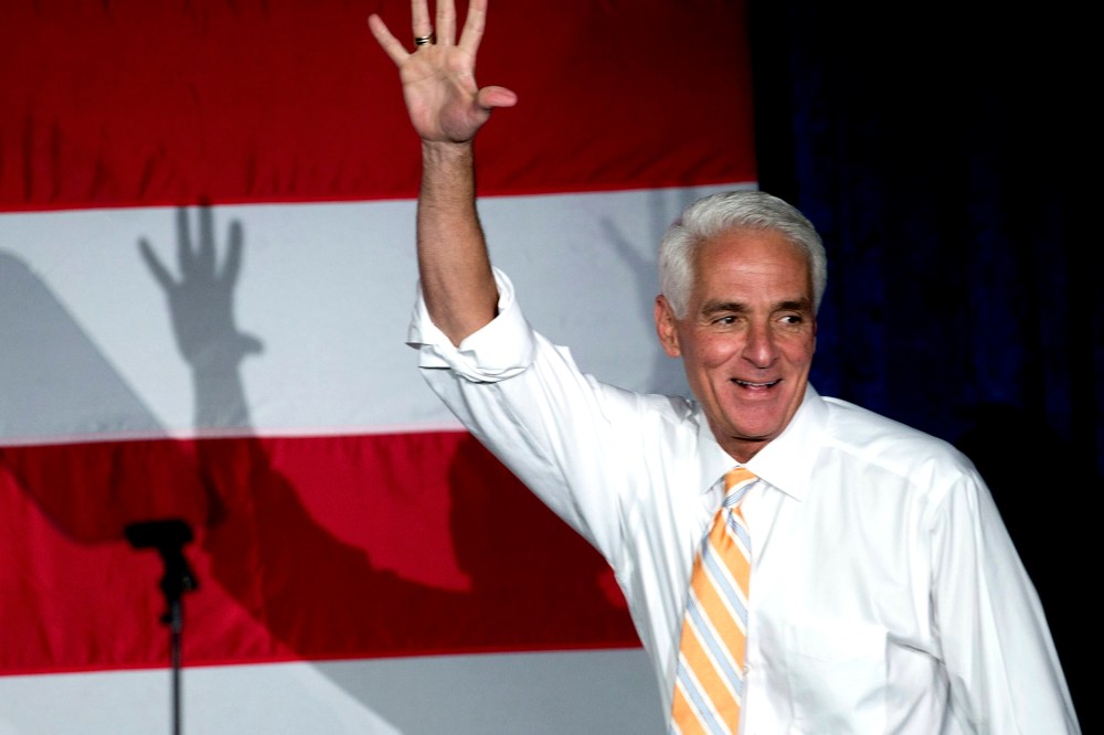 Former Florida Republican Gov. Charlie Crist, now running as a Democrat, waves to supporters during a campaign event, on Oct. 17, 2014, in Miami Gardens, Fla.