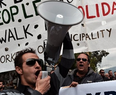Municipality workers shout slogans during a demonstration outside the Interior Ministry against the new austerity measures in Athens on November 23, 2012. The EU and the International Monetary Fund are working on a compromise to break deadlock on...